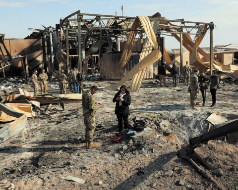Damage at Al Asad Airbase in Iraq following an Iranian-aligned militia missile attack, with US military personnel inspecting destroyed structures. Photo: US Department of Defense / Public Domain