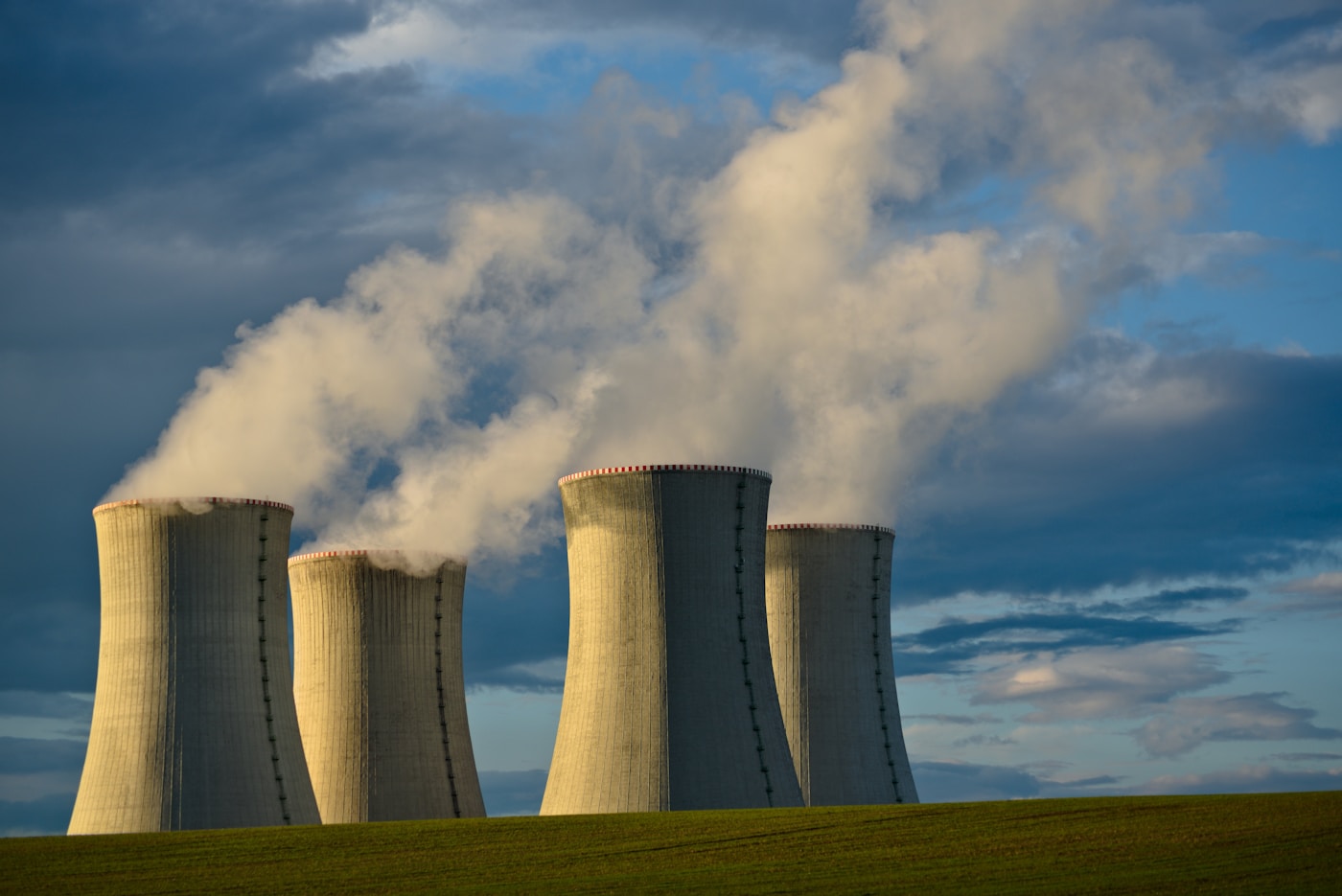 Nuclear power plant cooling towers releasing steam, representing the threat posed by Iran Bushehr reactor to Gulf states during the 2026 war