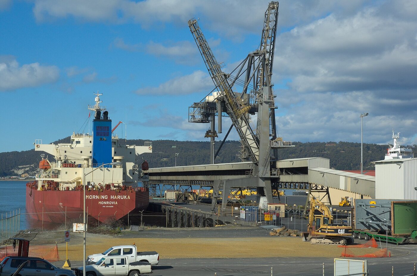 Bulk cargo ship at port with loading cranes, representing the global food supply chain that Saudi Arabia depends on for 85 percent of its food imports