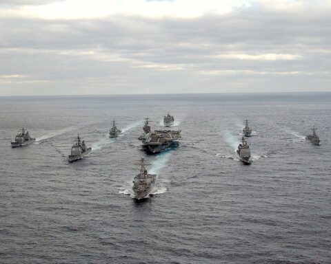 U.S. Navy carrier strike group sailing in formation — the kind of multinational fleet Trump called for but no ally has committed to the Strait of Hormuz. Photo: U.S. Navy / Public Domain