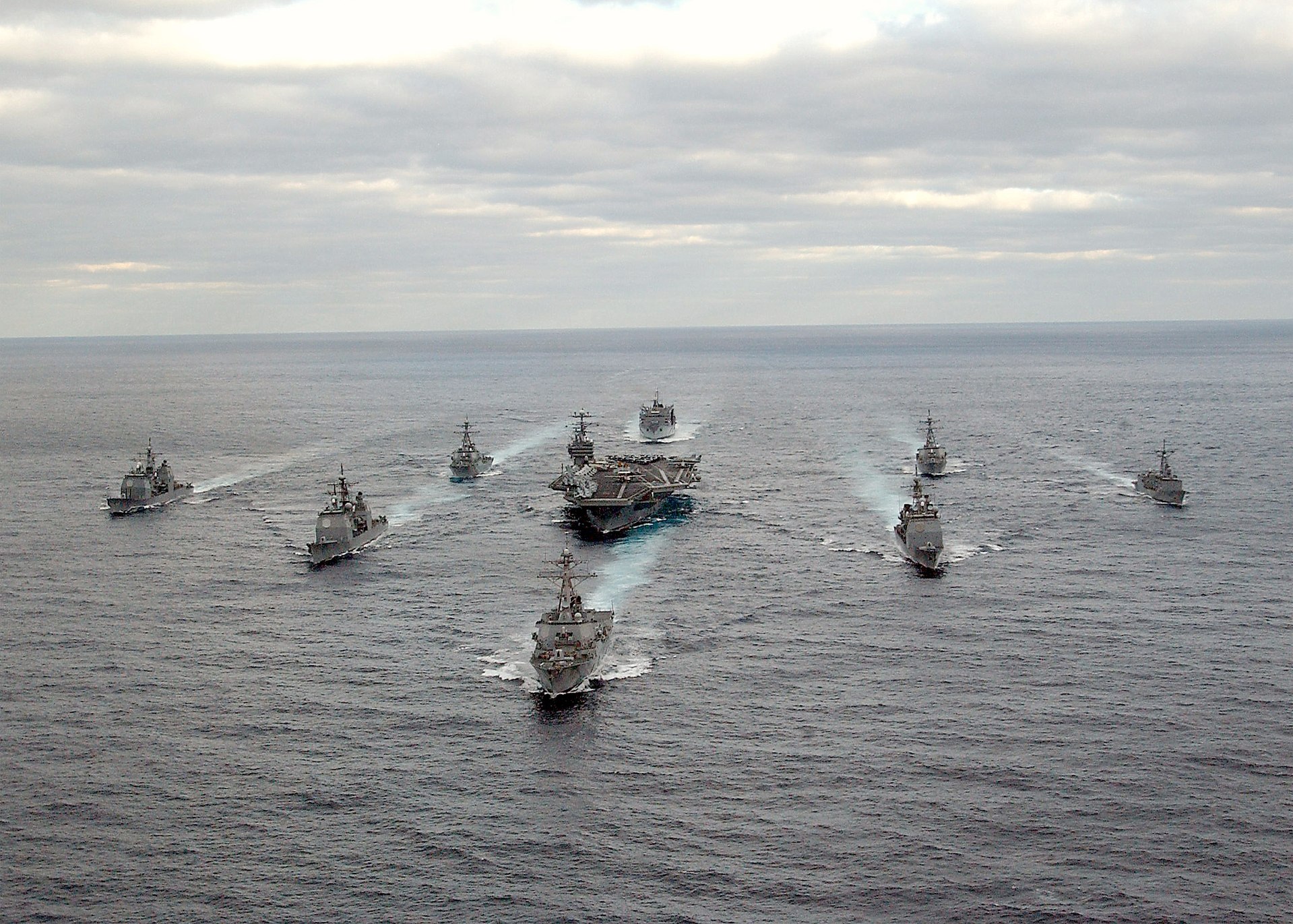 U.S. Navy carrier strike group sailing in formation — the kind of multinational fleet Trump called for but no ally has committed to the Strait of Hormuz. Photo: U.S. Navy / Public Domain