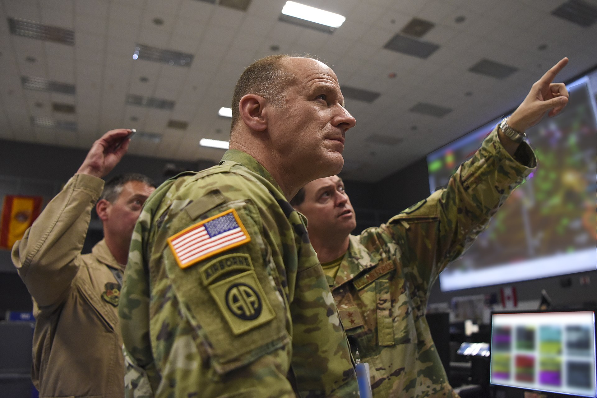 U.S. military commanders review operational displays at the Combined Air Operations Center at Al Udeid Air Base, the nerve center for American air campaigns across the Middle East