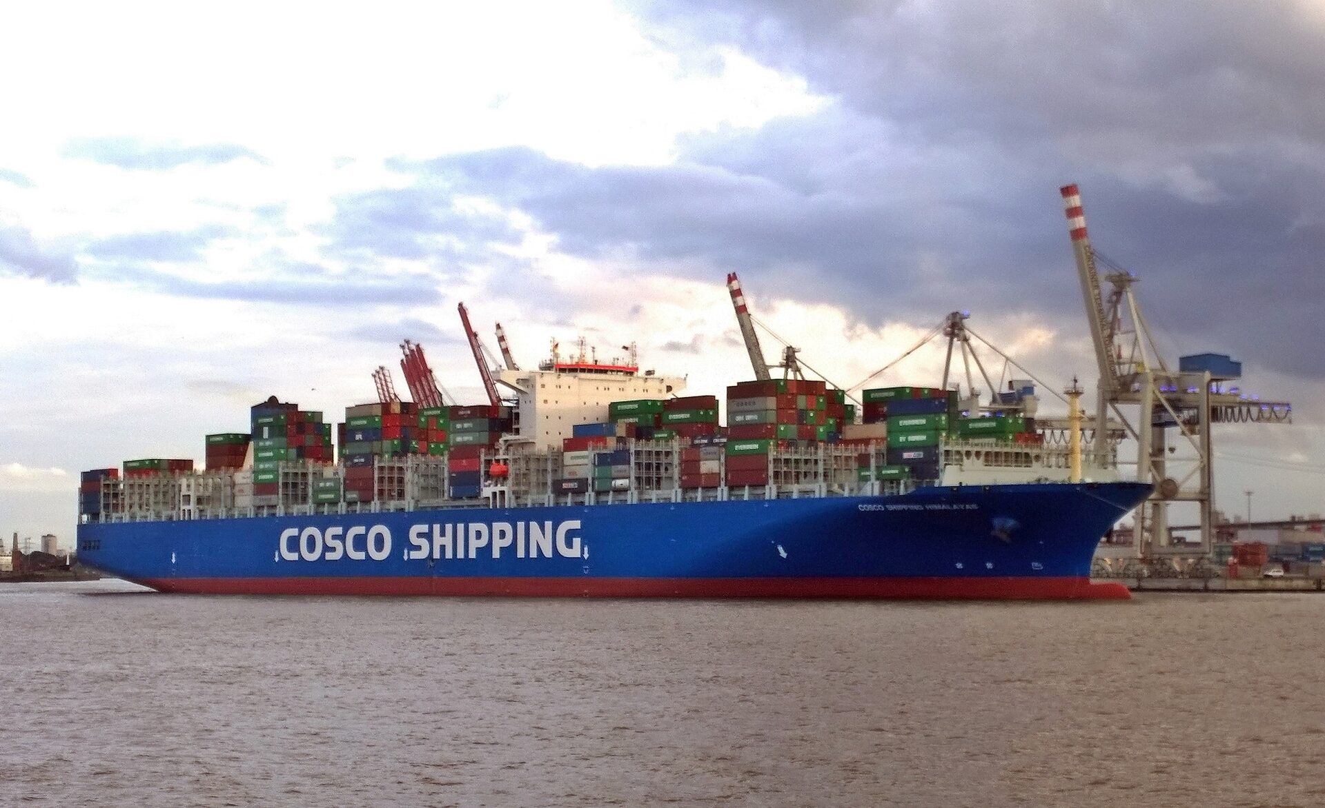 COSCO Shipping container vessel fully loaded with cargo containers at port