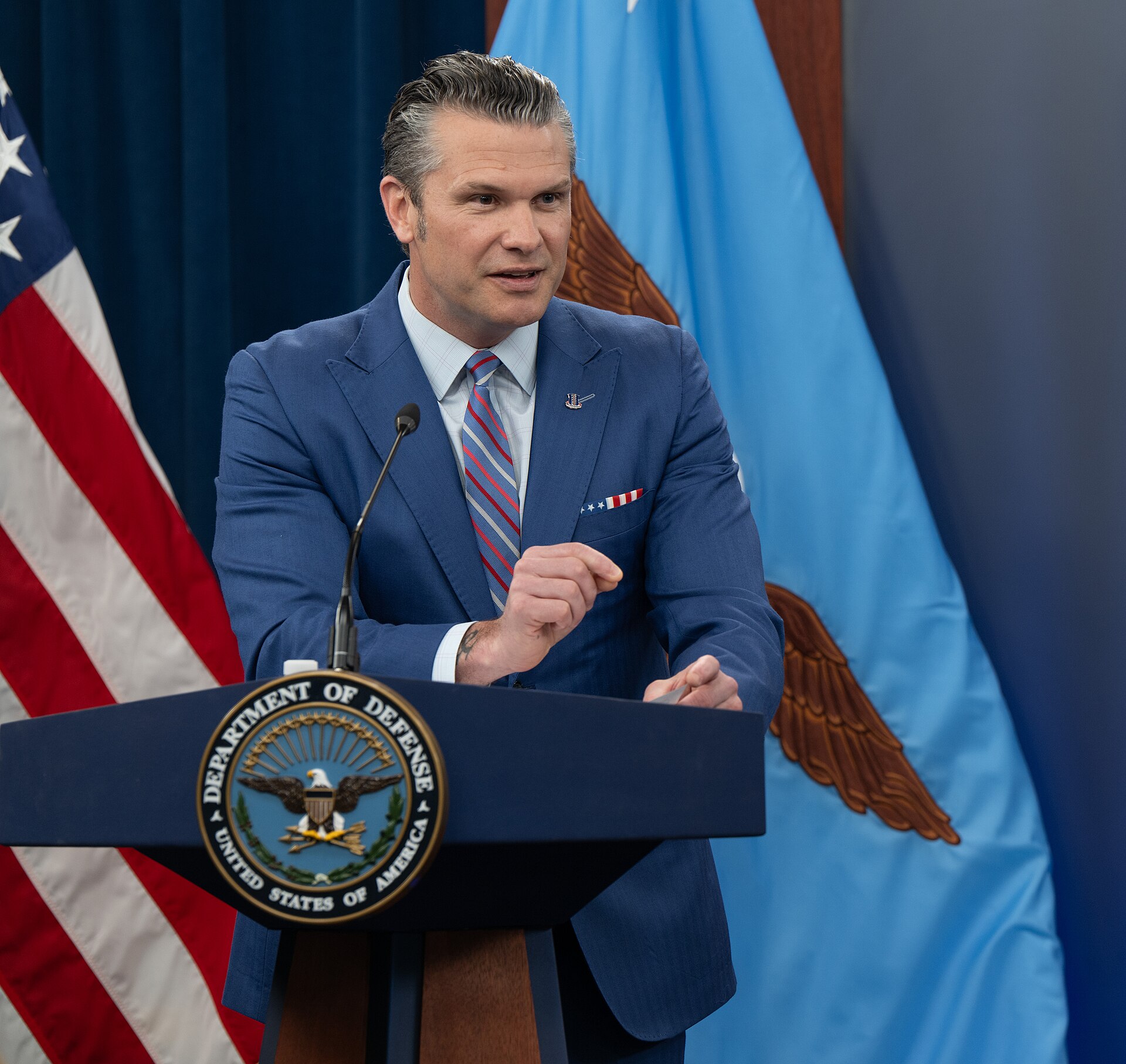 Defense Secretary Pete Hegseth at the Pentagon podium during an Iran war press briefing in June 2025. Photo: U.S. Department of Defense / Public Domain