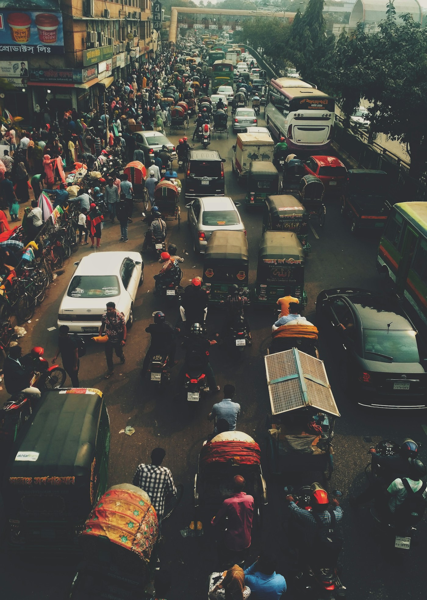 Congested street scene in Dhaka, Bangladesh showing dense traffic of rickshaws, buses, and motorcycles in one of the worlds most fuel-dependent megacities