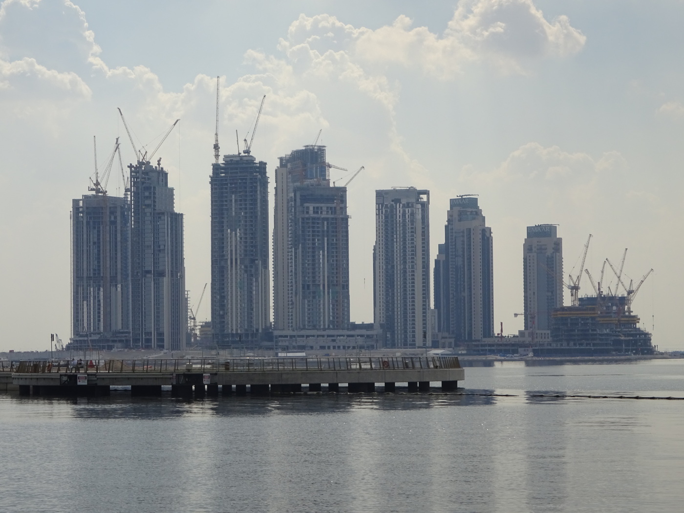 Dubai Creek skyline showing multiple towers under construction with cranes, built by migrant labor from South and Southeast Asia. Photo: Wikimedia Commons / CC BY-SA 4.0