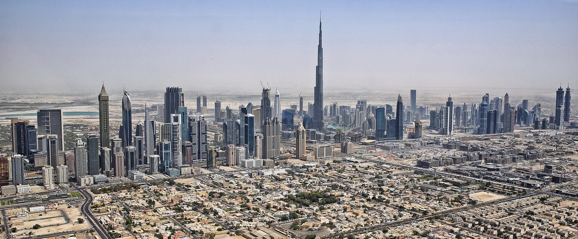 Aerial view of Dubai skyline with Burj Khalifa, the financial and commercial hub whose economic model faces unprecedented disruption from the Iran war