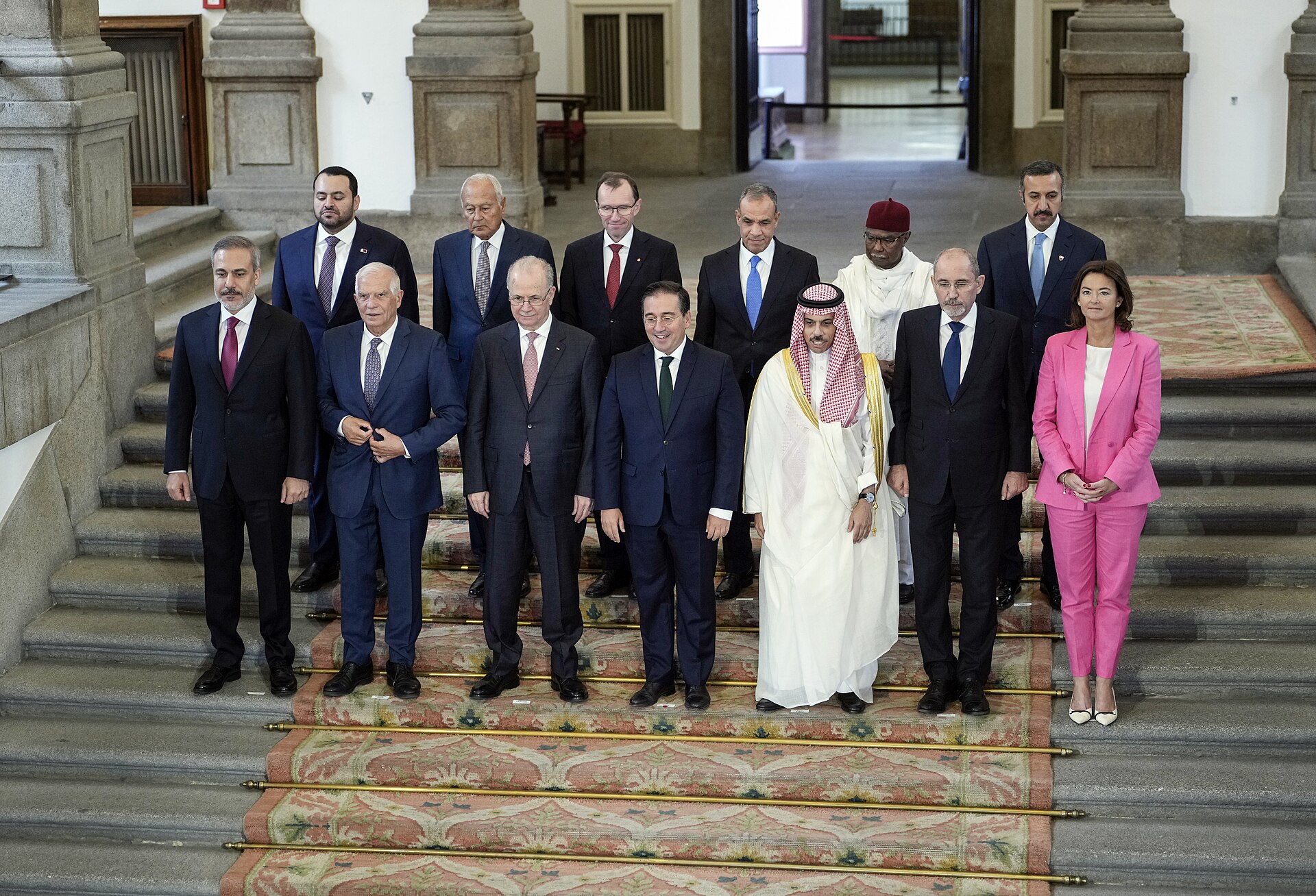 Turkish Foreign Minister Hakan Fidan and Saudi Foreign Minister Prince Faisal bin Farhan in a multilateral diplomatic group photo at the Madrid meeting in 2024