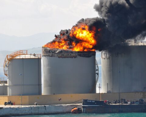Oil storage tanks engulfed in fire at a port facility, illustrating the type of damage caused by Iranian drone strikes on the UAE Fujairah oil terminal. Photo: Wikimedia Commons / CC BY-SA 2.0