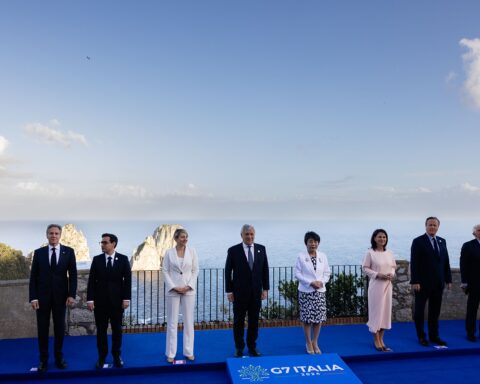 G7 foreign ministers stand for a group photo at the Capri summit in Italy, with the Mediterranean Sea behind them