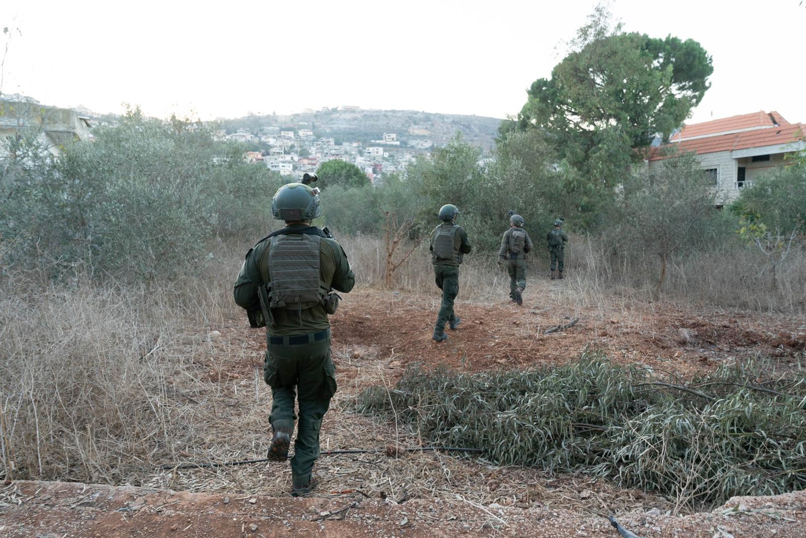IDF soldiers on foot patrol advancing through Lebanese terrain near a village during ground operations in southern Lebanon. Photo: IDF / Wikimedia Commons / CC BY-SA 3.0
