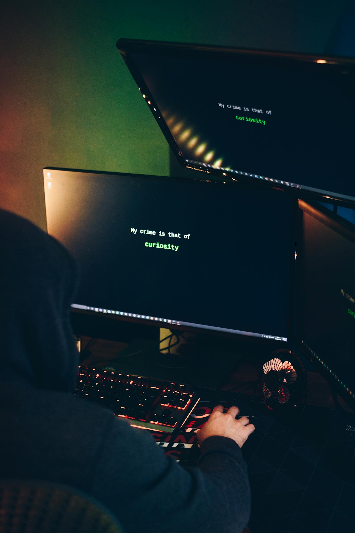 A cyber threat actor operating multiple screens in a dark room, representing Iranian state-sponsored hackers targeting Saudi critical infrastructure