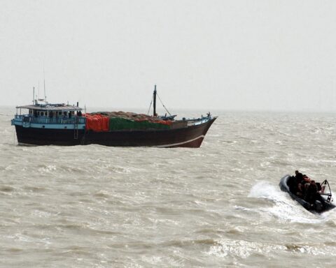 Naval boarding team approaches a cargo vessel in the Arabian Gulf as Iran imposes transit fees on Strait of Hormuz shipping. Photo: US Navy / Public Domain