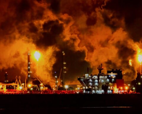 Oil facility engulfed in flames and toxic smoke at night during the Iran war, illustrating environmental damage to Gulf petroleum infrastructure