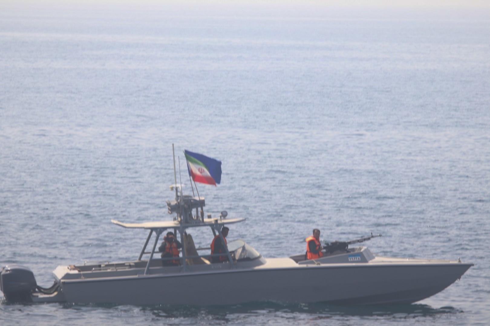 An Iranian IRGC Navy speedboat with mounted machine gun patrols near the Strait of Hormuz, flying the Iranian flag. Photo: US Navy / Public Domain