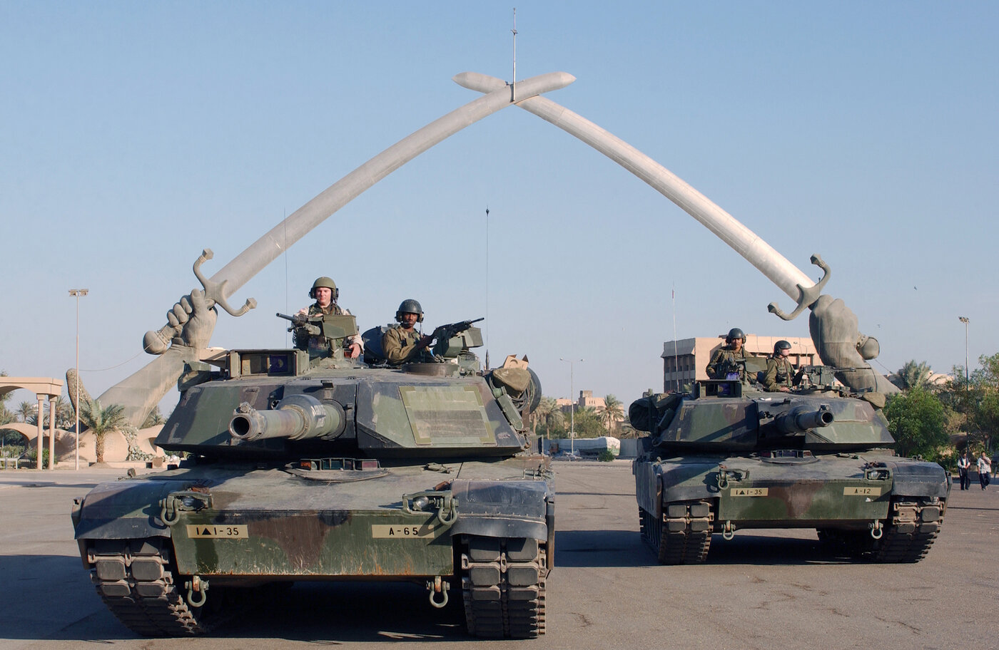 U.S. Army M1A1 Abrams tanks positioned under the Victory Arch in Baghdad, Iraq, symbolizing the American military presence that has shaped Iraqi politics for two decades. Photo: U.S. Department of Defense / Public Domain