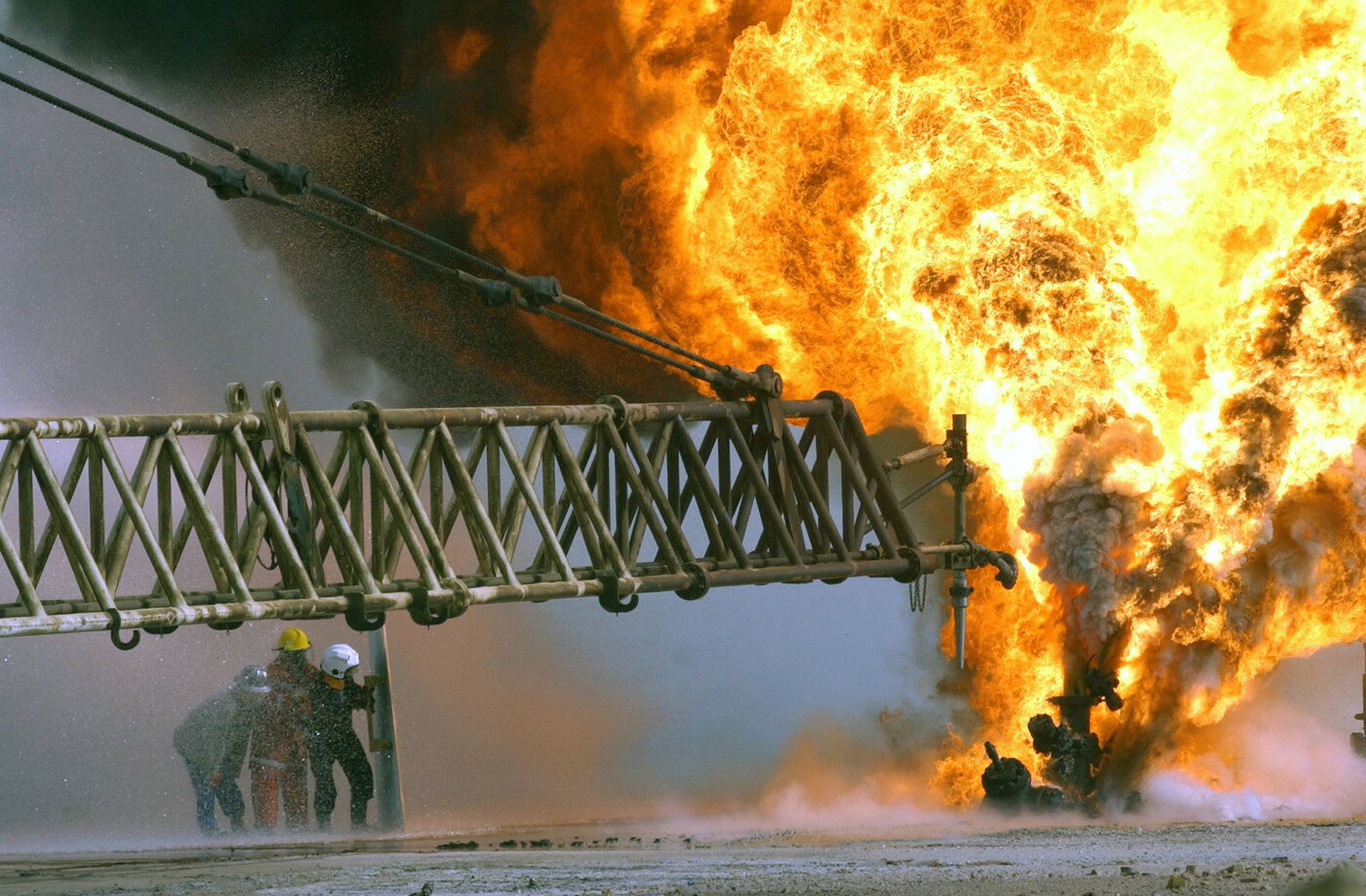 Firefighters battle a blazing oil well in the Rumaila oilfields of southern Iraq, one of the largest petroleum deposits in the Middle East and a critical node in global energy supply chains. Photo: U.S. Navy / Public Domain