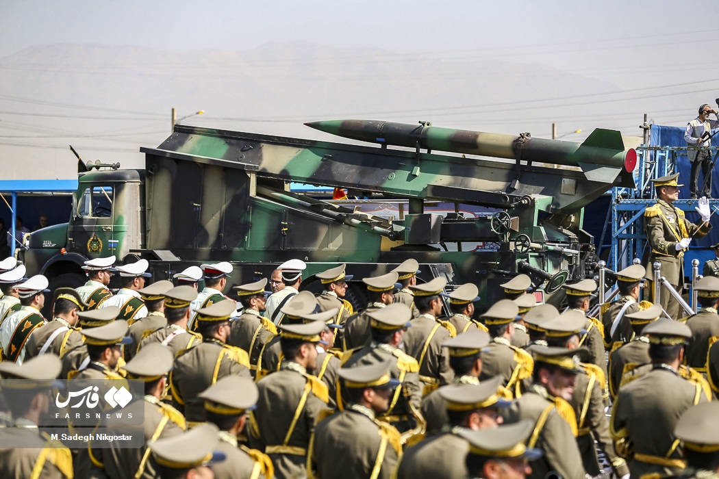 Iranian military missile launcher passes rows of uniformed officers during Sacred Defence Week parade in Tehran
