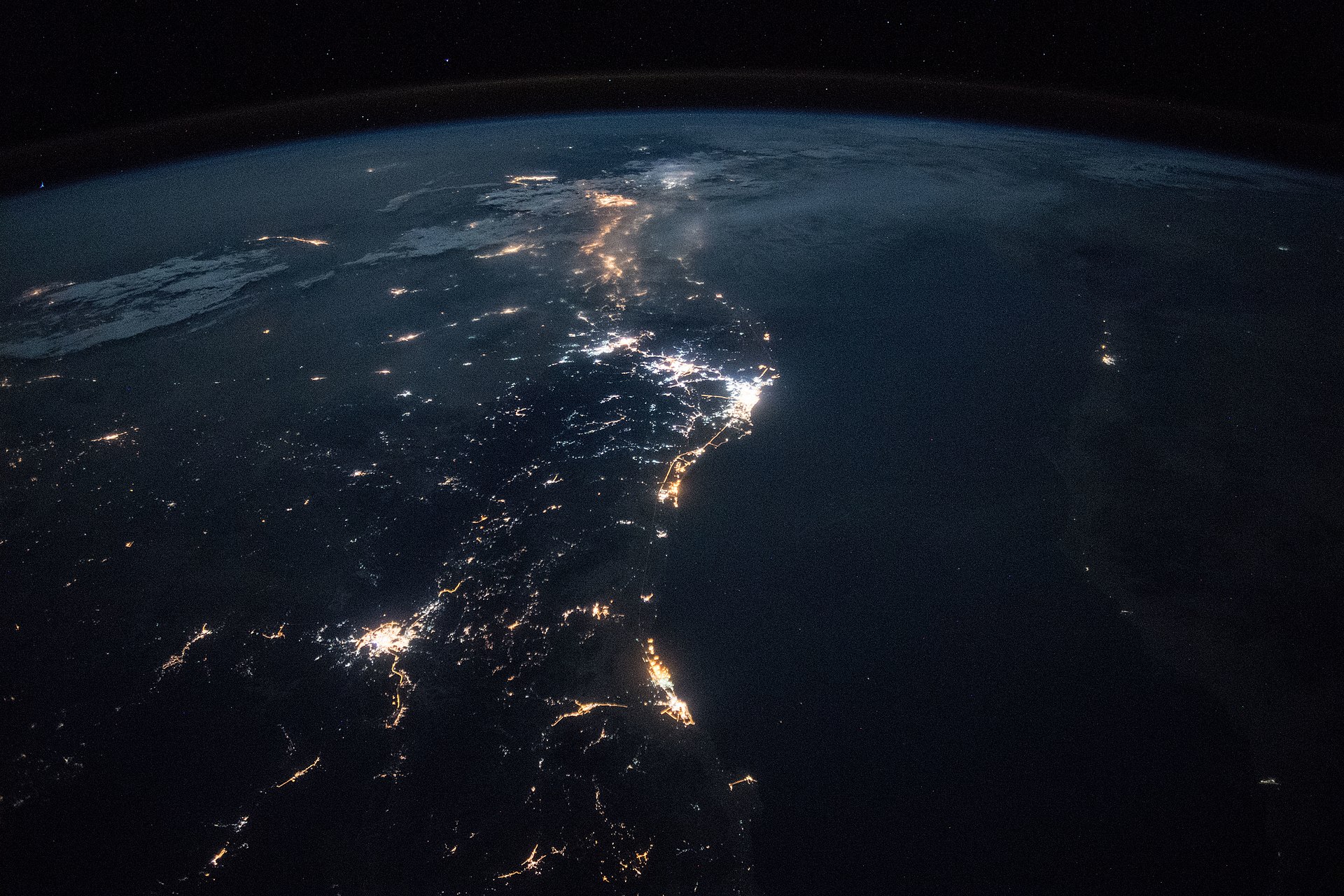 ISS nighttime photograph of Saudi Arabia showing the Red Sea coast, Yanbu, Jeddah, and oil infrastructure illumination across the kingdom