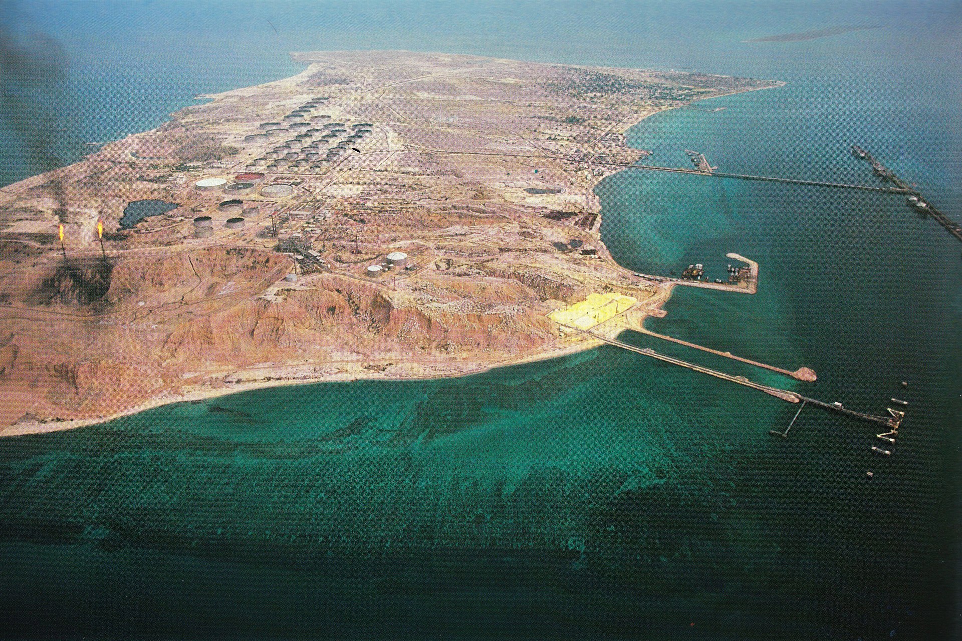 Aerial view of Kharg Island, Iran, showing oil storage tanks and tanker loading jetties that handle 90 percent of Iranian crude exports through the Persian Gulf