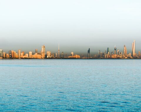 Kuwait City skyline viewed from the Persian Gulf showing the distinctive towers of the capital city now under Iranian drone and missile attack. Photo: Wikimedia Commons / CC BY 2.0