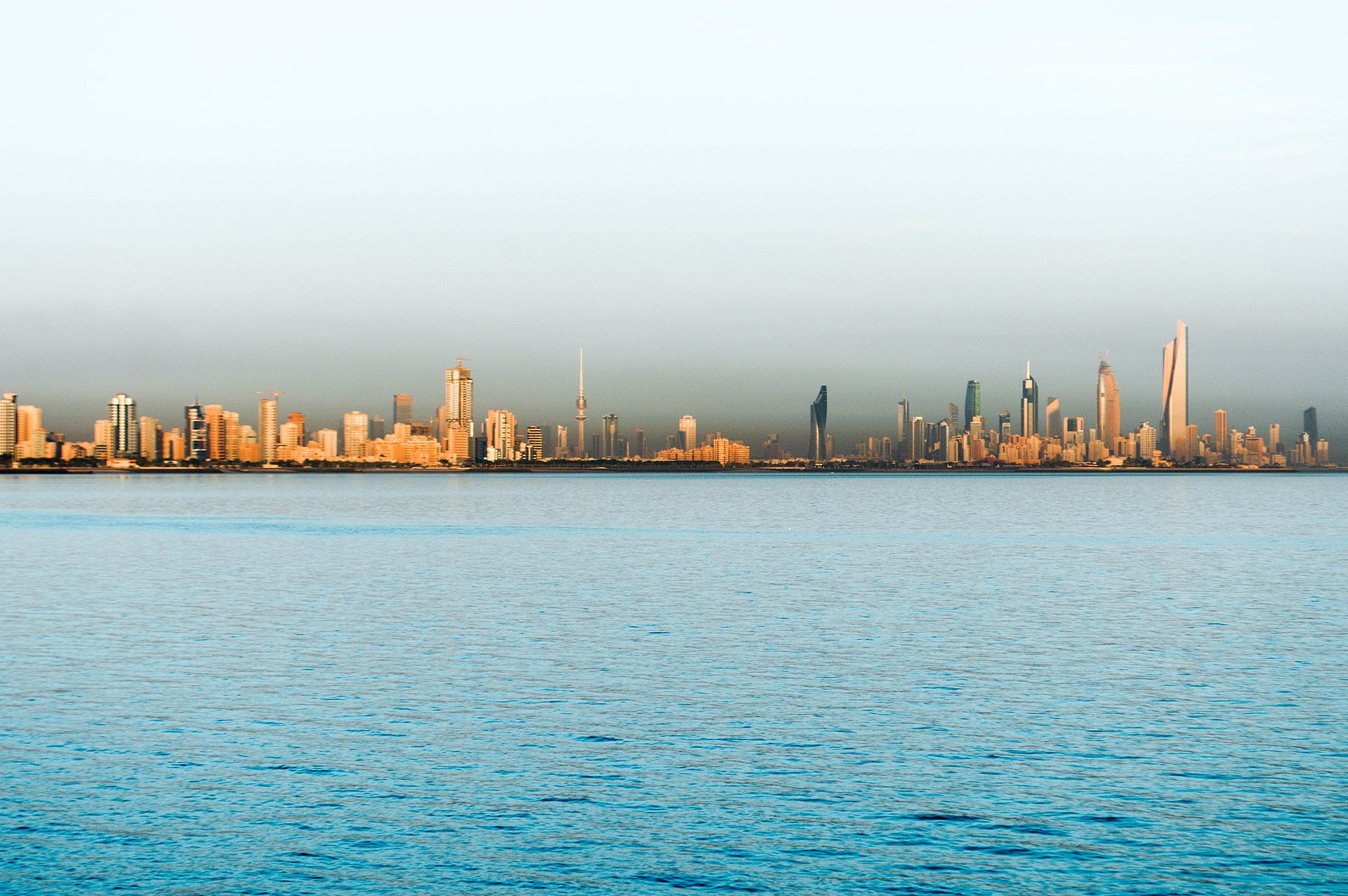 Kuwait City skyline viewed from the Persian Gulf showing the distinctive towers of the capital city now under Iranian drone and missile attack. Photo: Wikimedia Commons / CC BY 2.0