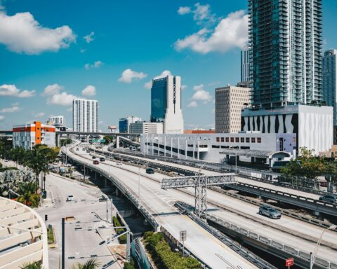 Miami skyline with highway and palm trees where the FII Priority Summit survived while Gulf events collapsed