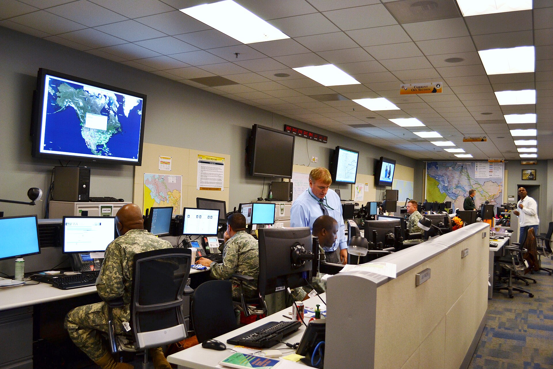 Military operations command center with personnel monitoring screens and tactical displays. Photo: US Army / Public Domain