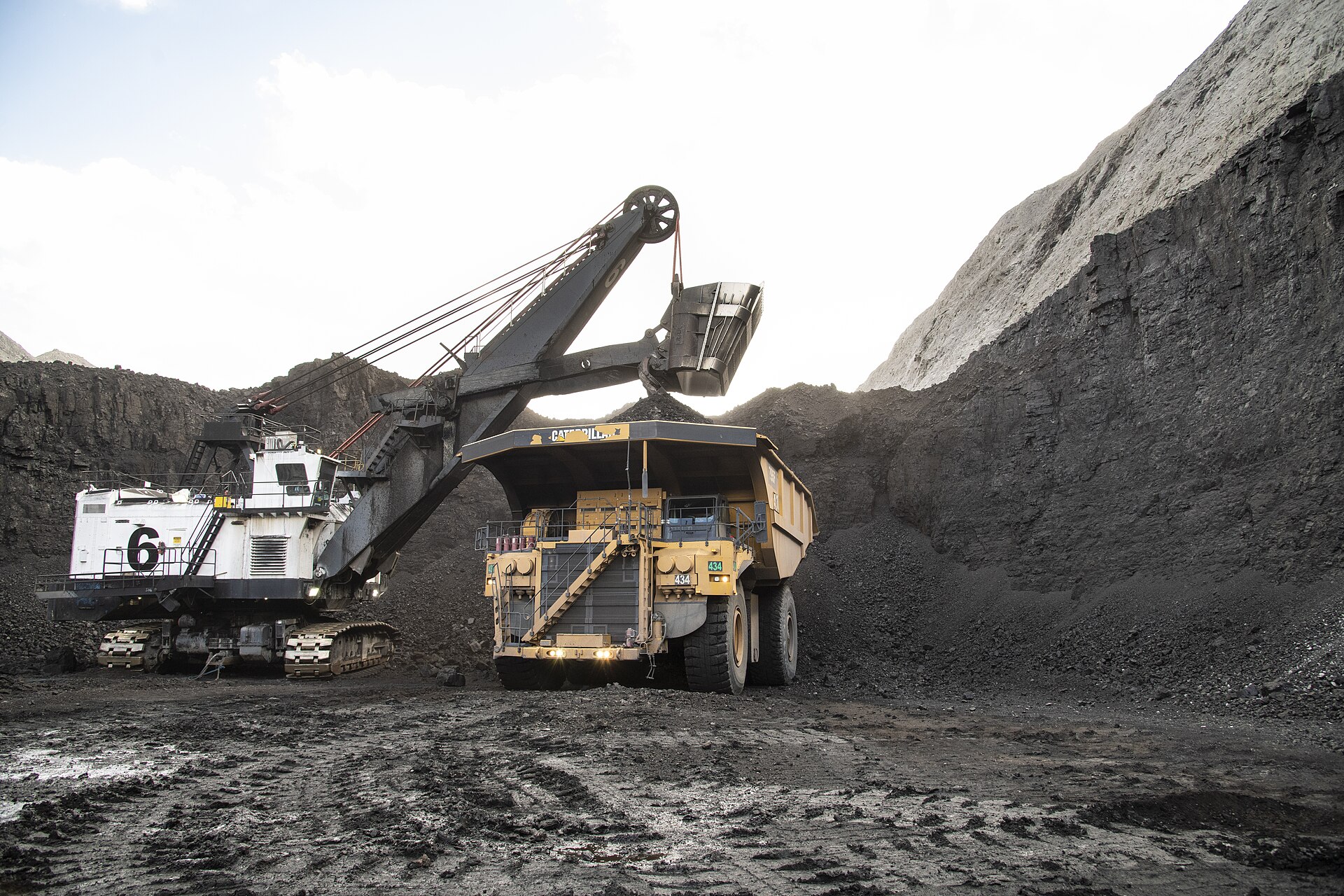 Heavy mining excavation equipment loading a haul truck at an open-pit mine site, illustrating the scale of modern mineral extraction operations. Photo: USDA / Public Domain