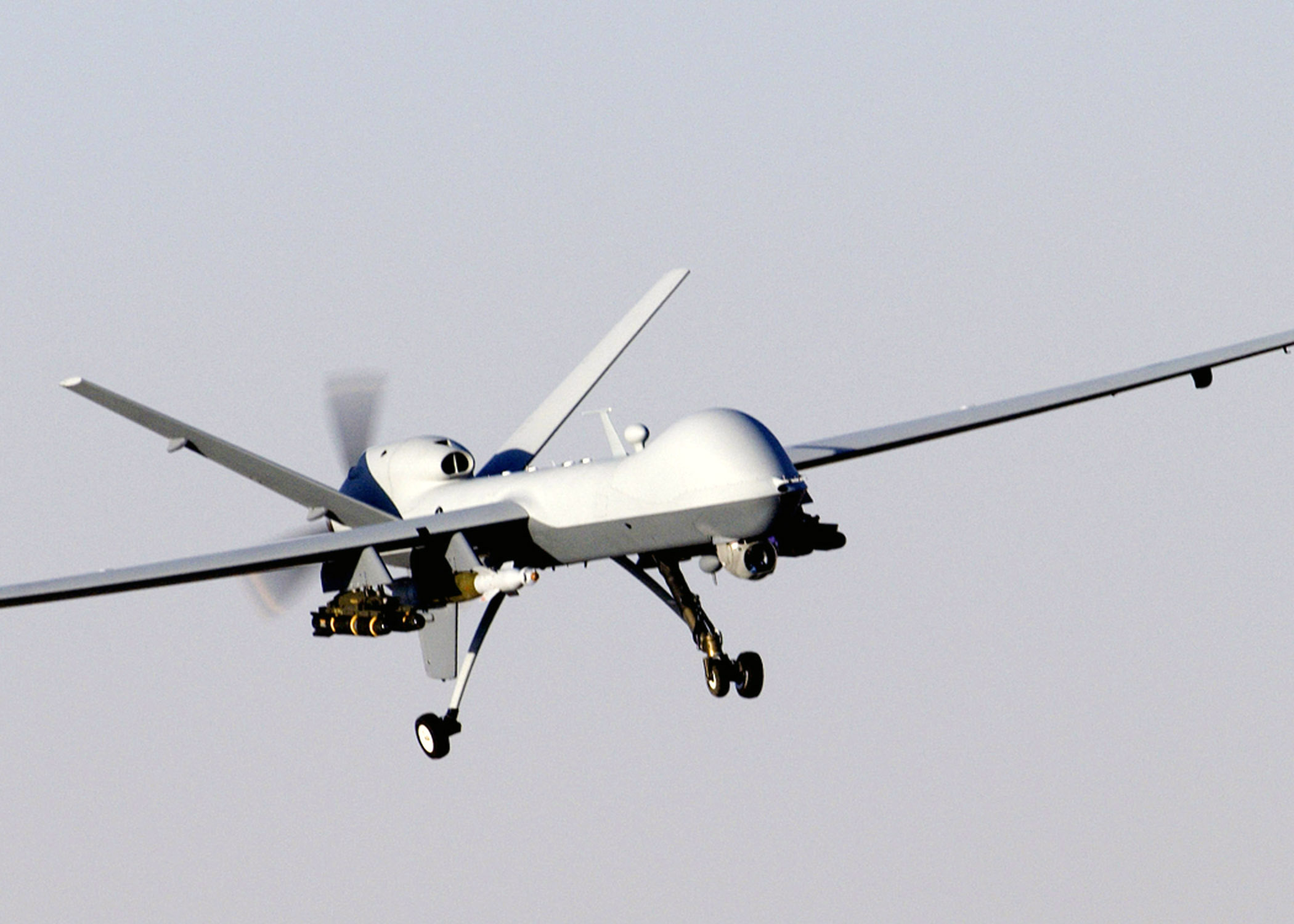 MQ-9 Reaper unmanned aerial vehicle in flight carrying precision-guided munitions, representing the autonomous drone warfare revolution reshaping Gulf defense