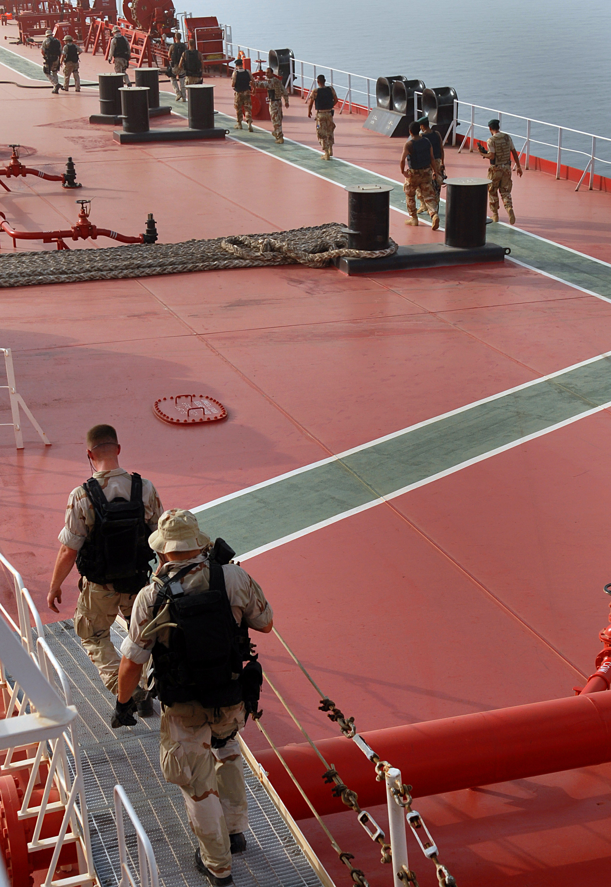 US Navy and coalition personnel conduct a visit, board, search, and seizure operation on an oil tanker in the Persian Gulf
