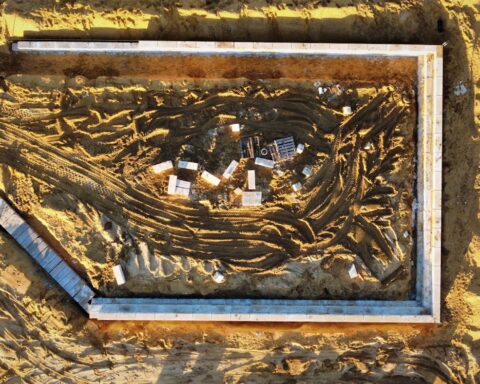 Aerial view of a construction foundation in desert sand, representing NEOM and Saudi megaproject development