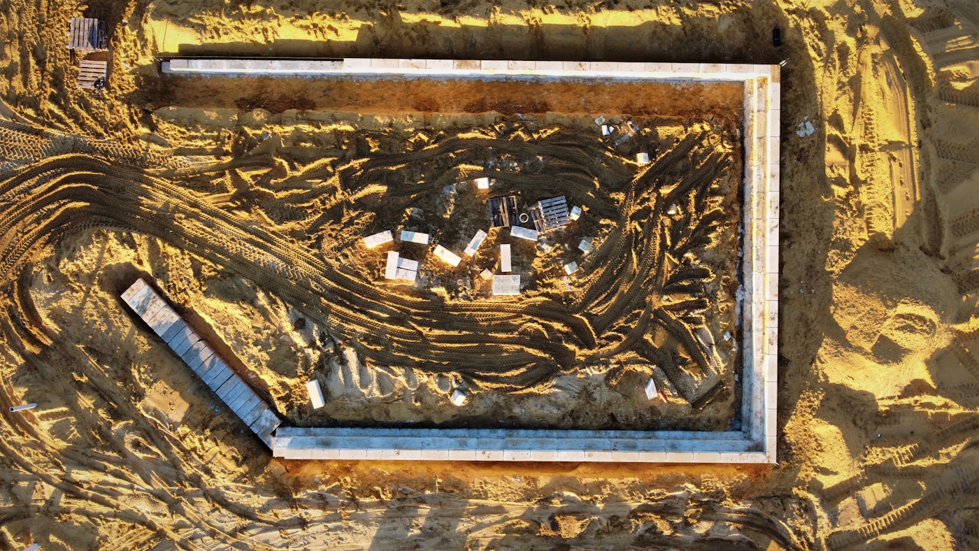 Aerial view of a construction foundation in desert sand, representing NEOM and Saudi megaproject development