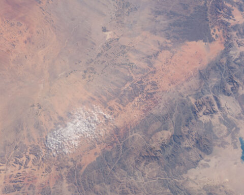 Satellite view of the NEOM zone in Tabuk Province, Saudi Arabia, showing vast desert terrain, mountains, and the Red Sea coast where the $500 billion megaproject was planned