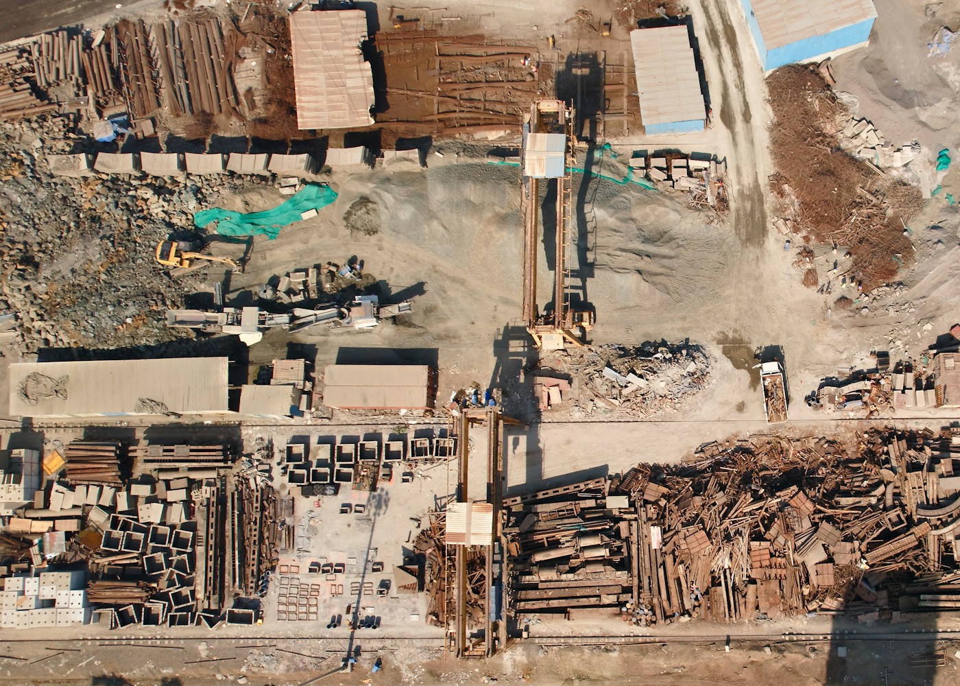 Aerial view of a large-scale construction site with heavy machinery and materials, representing the scale of NEOM megaproject work