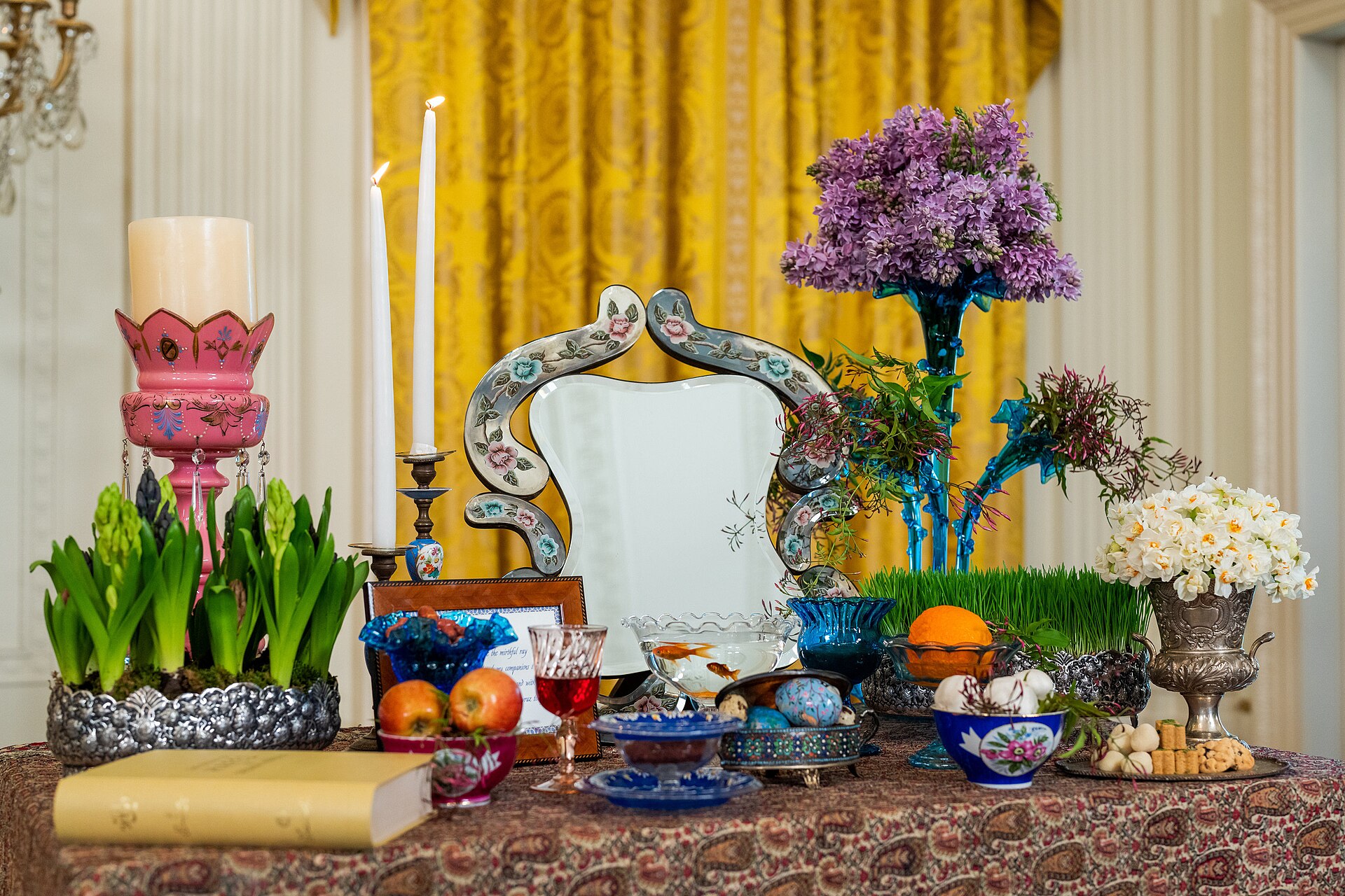 A traditional Haft-sin table set for Nowruz, the Persian New Year celebration. Nowruz 2026 fell during the third week of the Iran war, the first time the holiday has been marked during active conflict since the Iran-Iraq War. Photo: White House / Public Domain