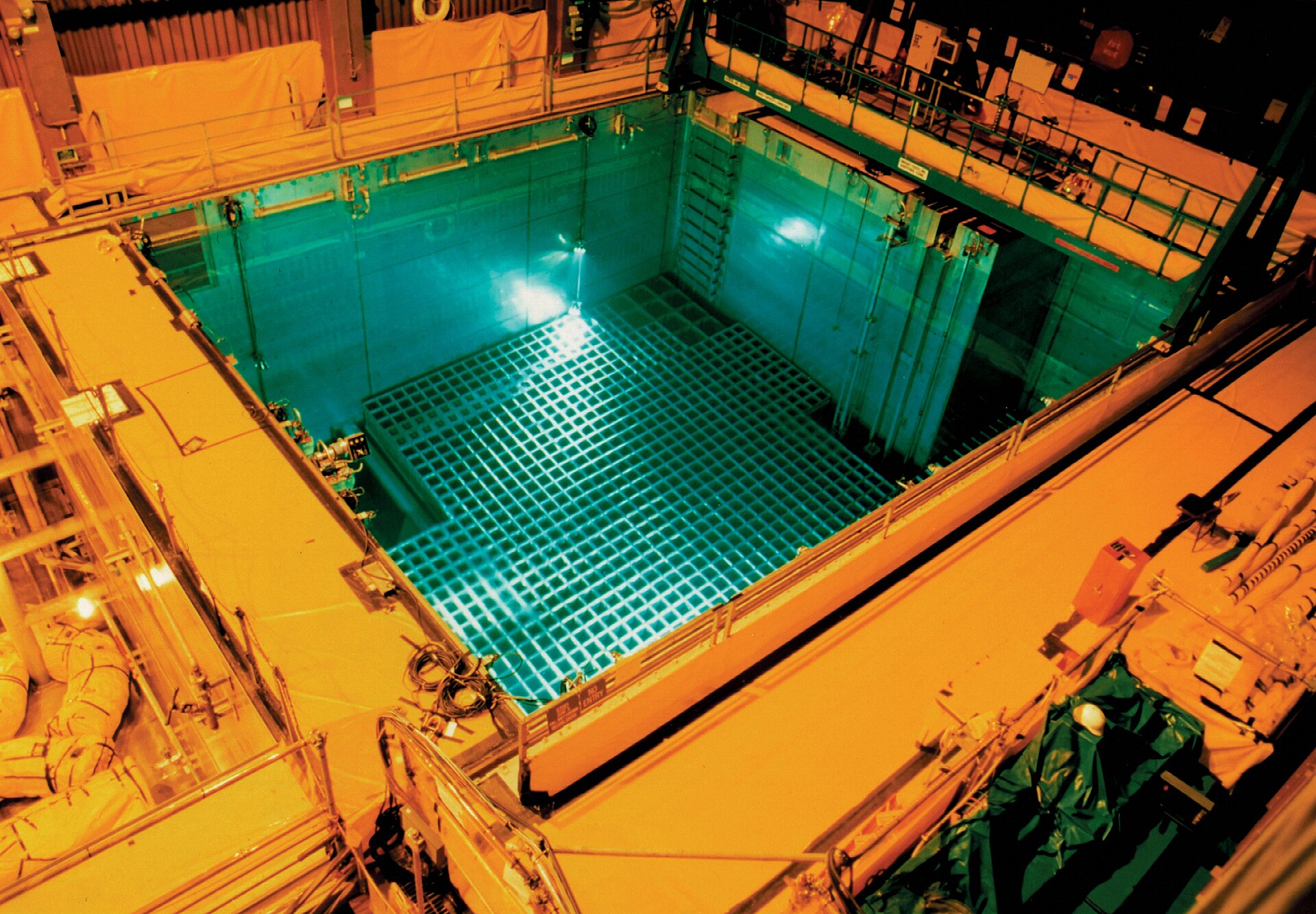 A spent nuclear fuel pool glowing with Cherenkov radiation at a nuclear power station. Bushehr stores 210 tons of spent fuel that could contaminate the Gulf if struck. Photo: US NRC / CC BY 2.0