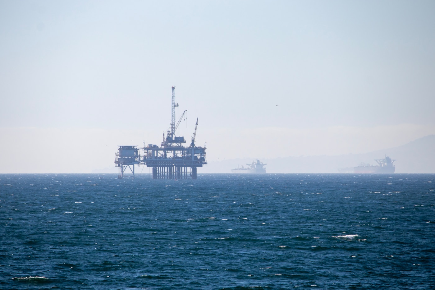 Offshore oil platform in open waters with vessels in the background, similar to Saudi Aramco Safaniya offshore facilities in the Persian Gulf