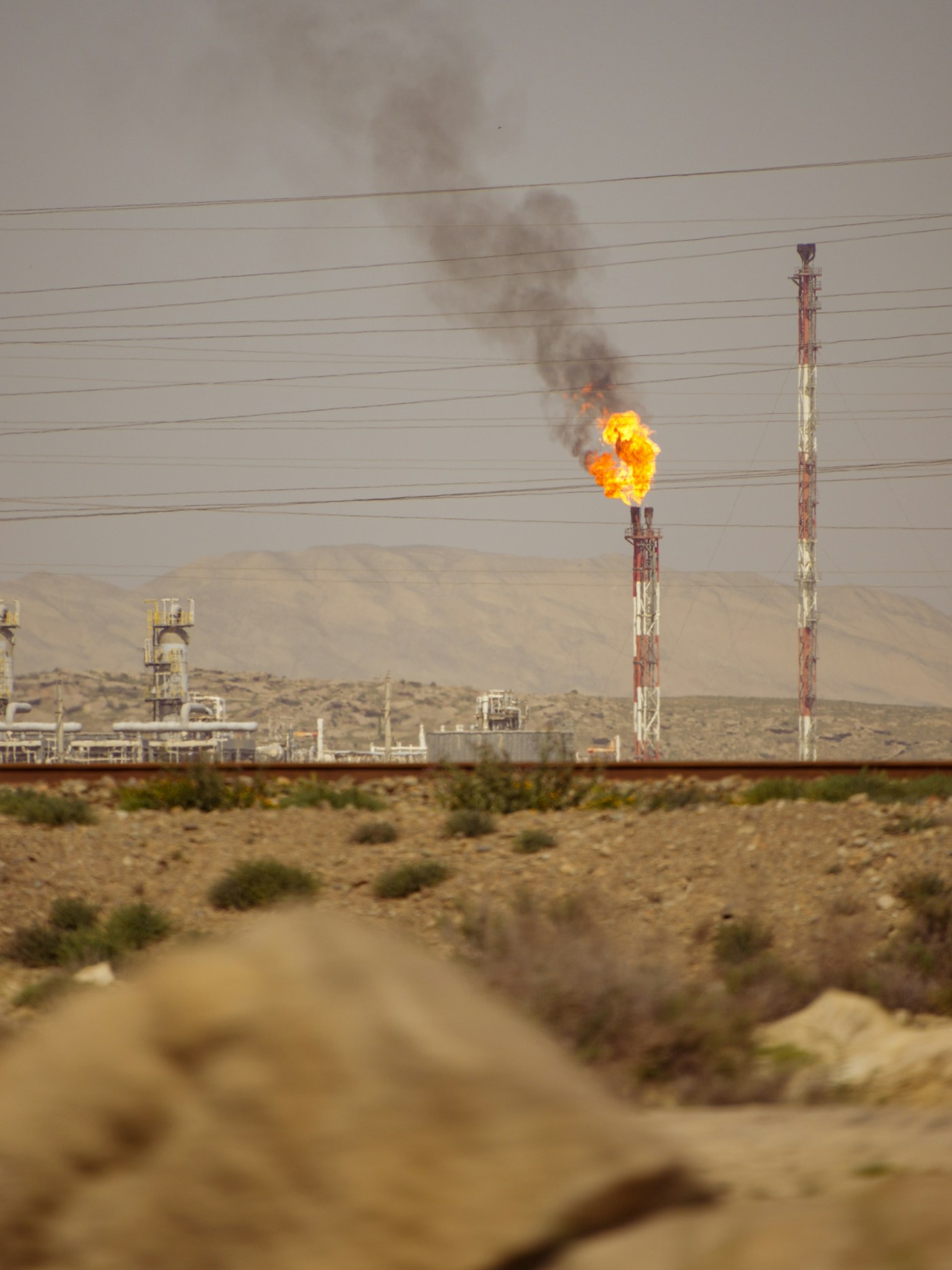 Oil refinery gas flare in the Gulf region where energy infrastructure has been targeted by Iran-backed militia attacks from Iraqi territory