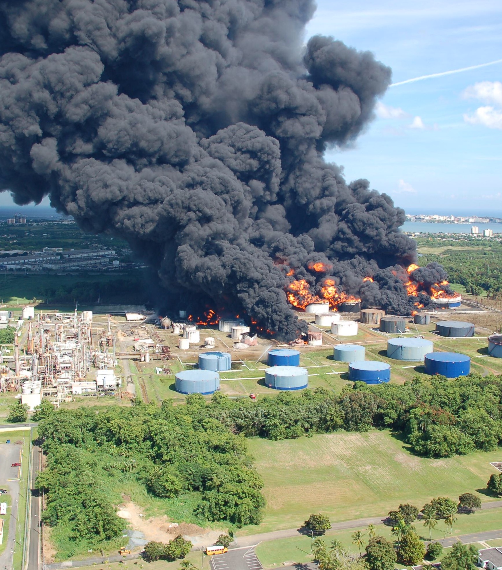 Massive fire and explosion at an oil storage facility, illustrating the vulnerability of fossil fuel infrastructure to catastrophic disruption