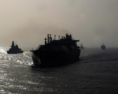 Naval warships escort a large gas tanker through the Persian Gulf during convoy operations. Photo: US Navy / Public Domain
