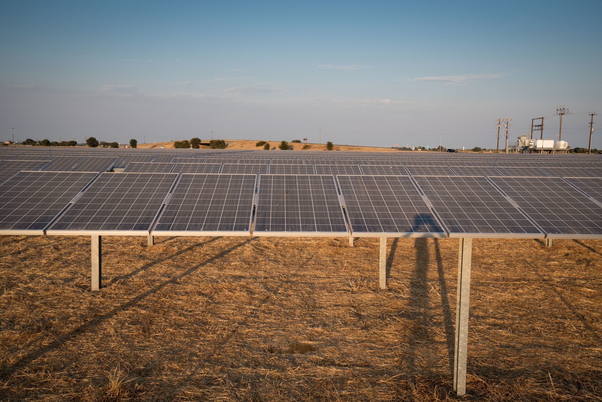 Large-scale photovoltaic solar power station with thousands of panels arranged in rows, representing the rapid global scale-up of renewable energy capacity