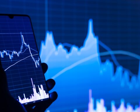 Financial trading chart on a smartphone screen showing volatile market movements during the Iran war ceasefire speculation period in March 2026
