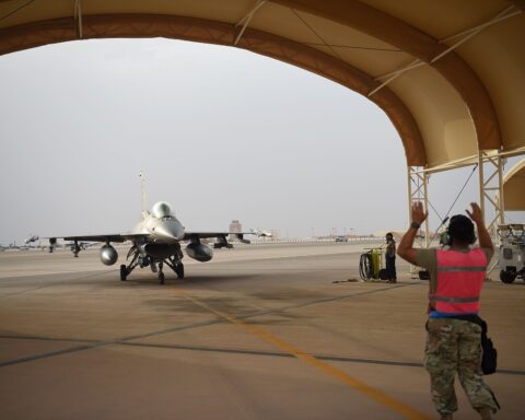 U.S. Air Force F-16 Fighting Falcon being marshalled into a parking shelter at Prince Sultan Air Base, Saudi Arabia, the largest American military footprint on the Arabian Peninsula