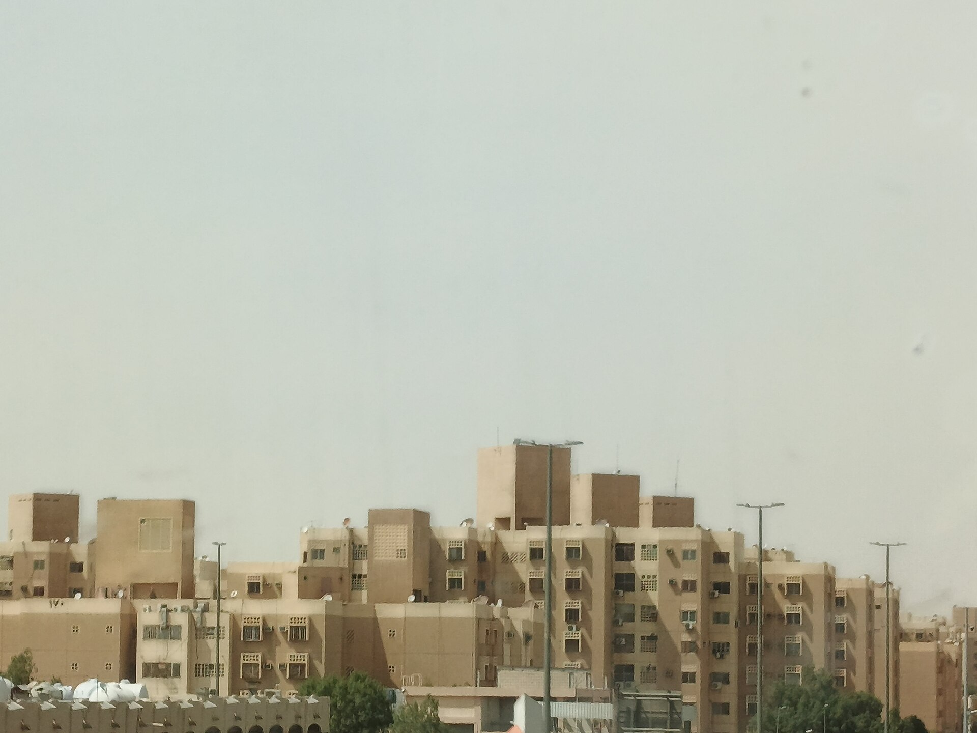 Residential apartment buildings along the Al-Kharj Road in southern Riyadh, Saudi Arabia, typical of the worker housing compounds found across the Kingdom