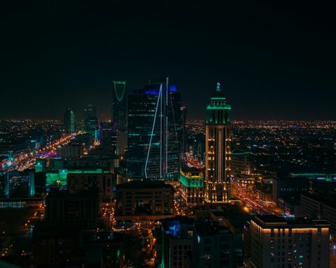 Riyadh business district skyline at night showing Kingdom Tower and corporate offices where Saudization employment rules apply