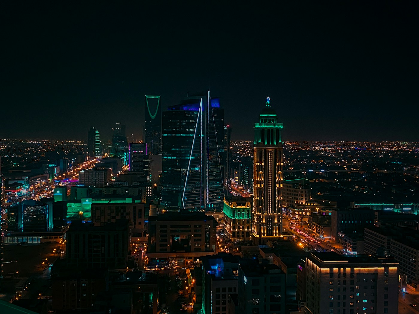 Riyadh business district skyline at night showing Kingdom Tower and corporate offices where Saudization employment rules apply