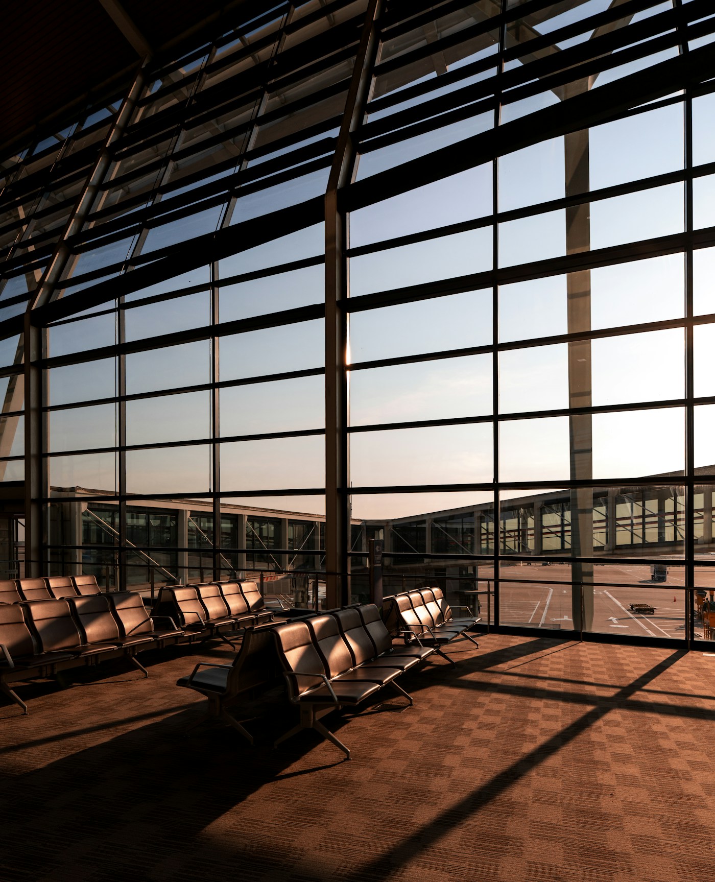 Modern airport terminal with panoramic windows and seating area