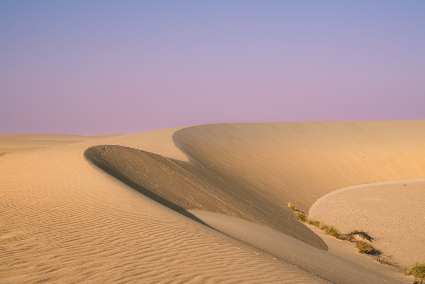 Golden sand dunes in the Saudi Arabian desert during golden hour