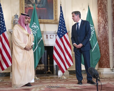 Saudi Foreign Minister Prince Faisal bin Farhan Al Saud in a bilateral diplomatic meeting with US and Saudi flags